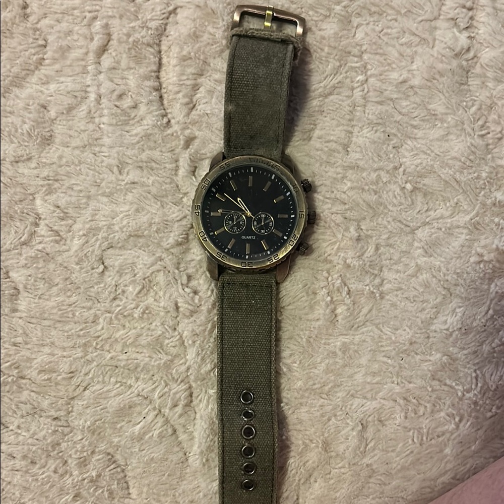 Elegant Watch with Green Strap and Black Face